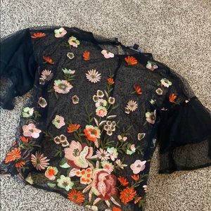 See through black flower embroidered top.
